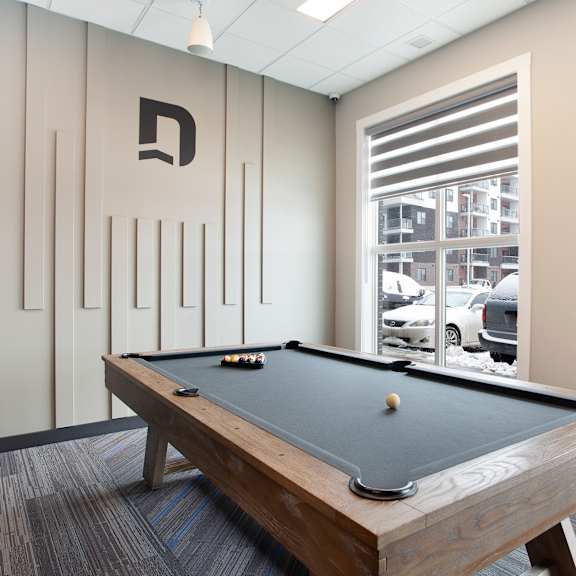recreation room with pool table and modern decor at plaza apartments, calgary, alberta