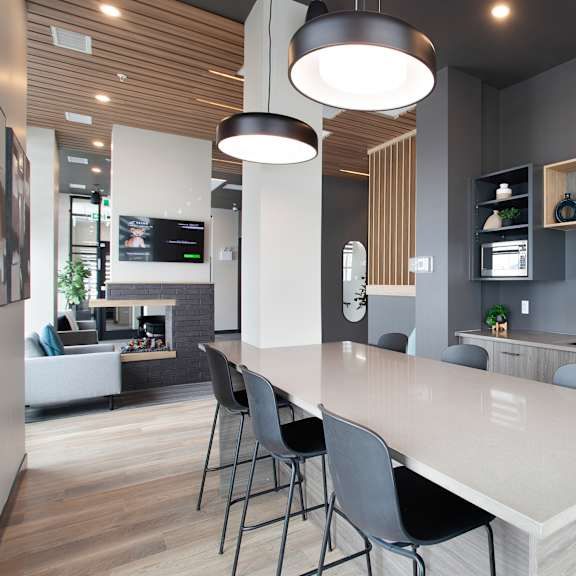 modern kitchen island with bar stools at plaza apartments, calgary, ab t2l 2m8