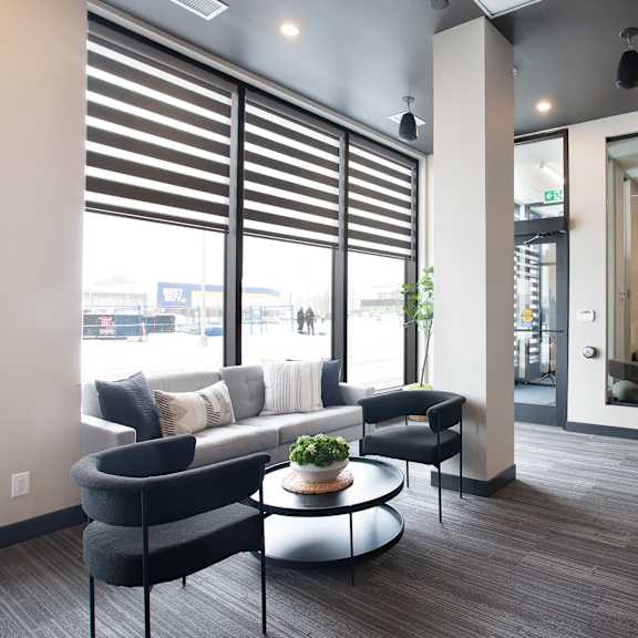 modern lobby with seating area and windows at plaza apartments, calgary, ab