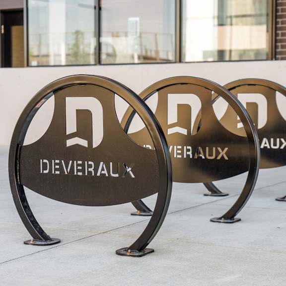 custom bronze bike racks with branding at plaza apartments, alberta, t2l 2m8