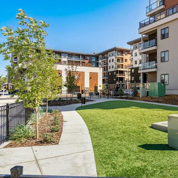 modern courtyard with circular lawn and walkways at plaza apartments, calgary, ab t2l 2m8