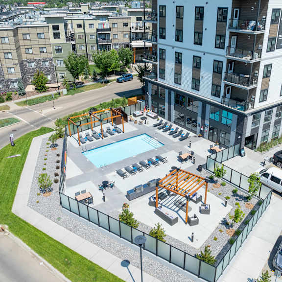 a view of a pool and playground area in a residential complex.