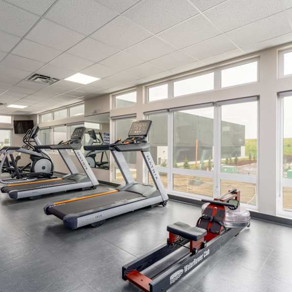 a gym with treadmills and exercise bikes. at g17 apartments at tamarack, edmonton