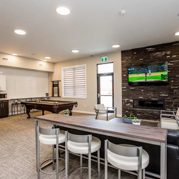 a modern living room with a pool table and a television.