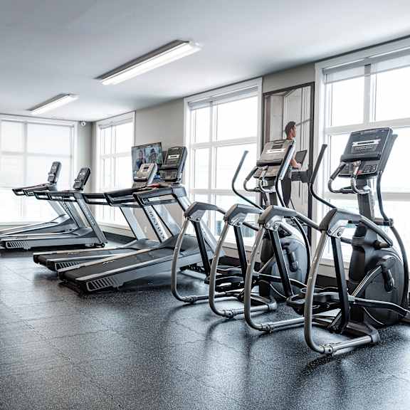 a gym with treadmills at podium apartments, calgary, ab