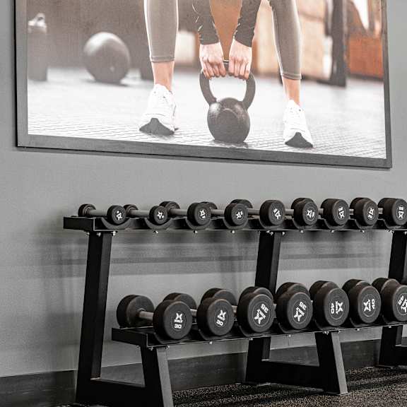 a gym with weights at podium apartments, alberta, t2e 7j2