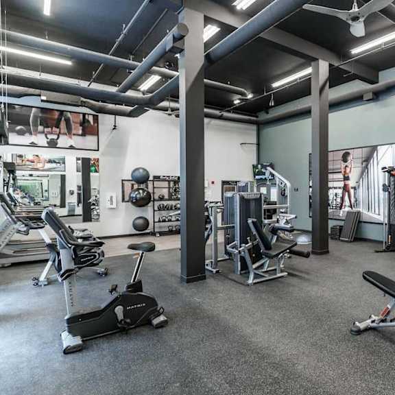 modern fitness center with exercise equipment at mac and mullen apartments, edmonton, alberta