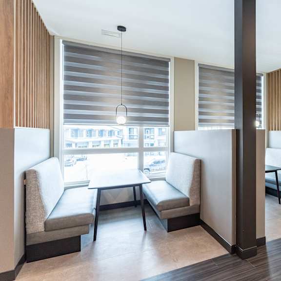 contemporary dining area with booth seating at mac and mullen apartments, alberta