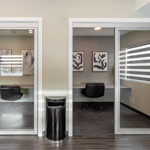 a room with a glass door and a black trash can.at vibe apartments at arbour lake, alberta