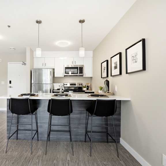a kitchen with a large island and a clock on the wall.
