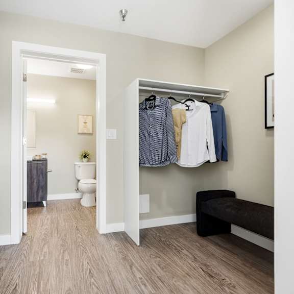 a small room with a toilet and a bench.