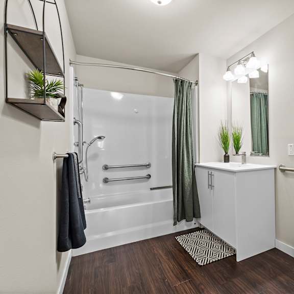 a bathroom with a toilet, sink, and shower.