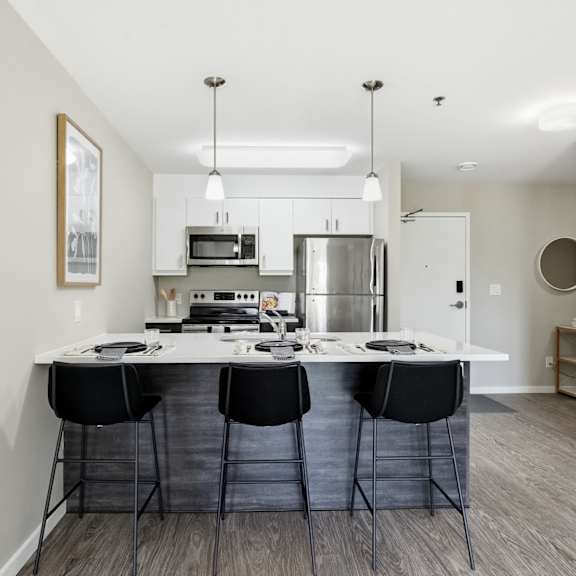 a kitchen with a table and chairs in the middle of the room.