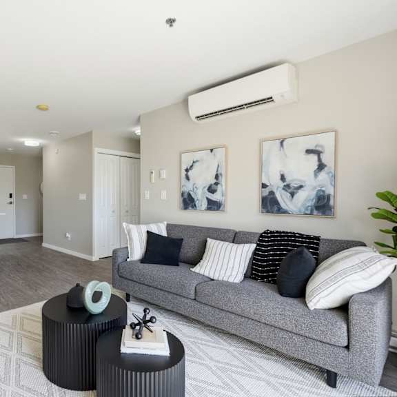 a living room with a grey couch and a coffee table.