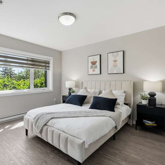 a bedroom with a large bed and a window with blinds.