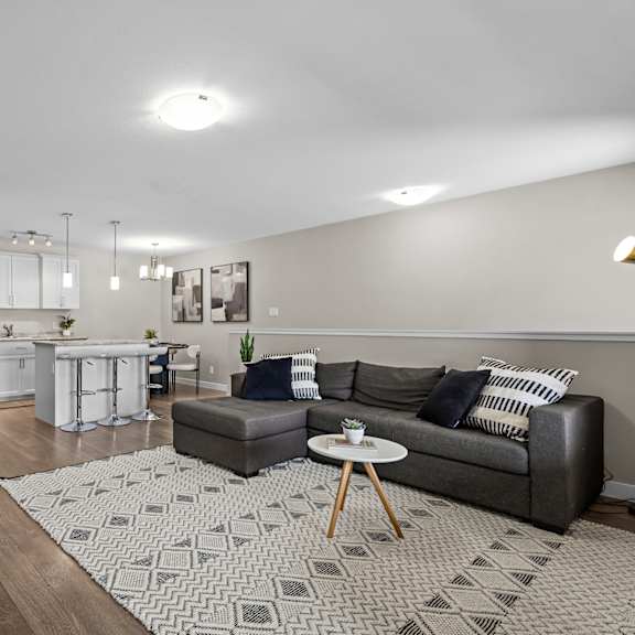 a living room with a grey couch and a coffee table.