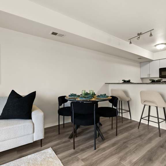 a modern kitchen with a dining table and chairs.