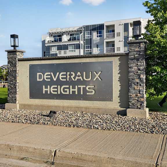 a sign that says deveraux heights in front of a building.
