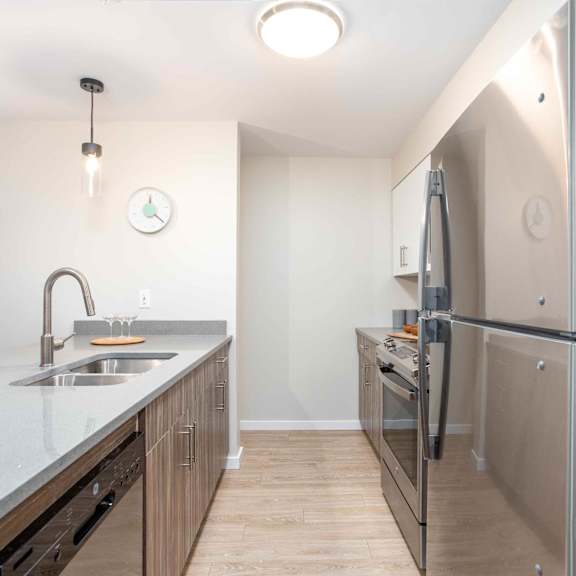 a kitchen with a sink, refrigerator, and cabinets. at g17 apartments at tamarack, edmonton, ab
