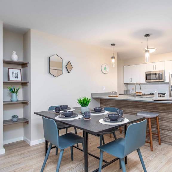 a kitchen with a dining table and chairs. at g17 apartments at tamarack, edmonton, t6t 2m4
