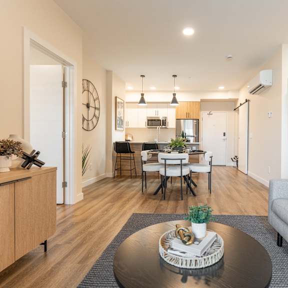 living room with kitchen view at vista apartments at edgemont, edmonton