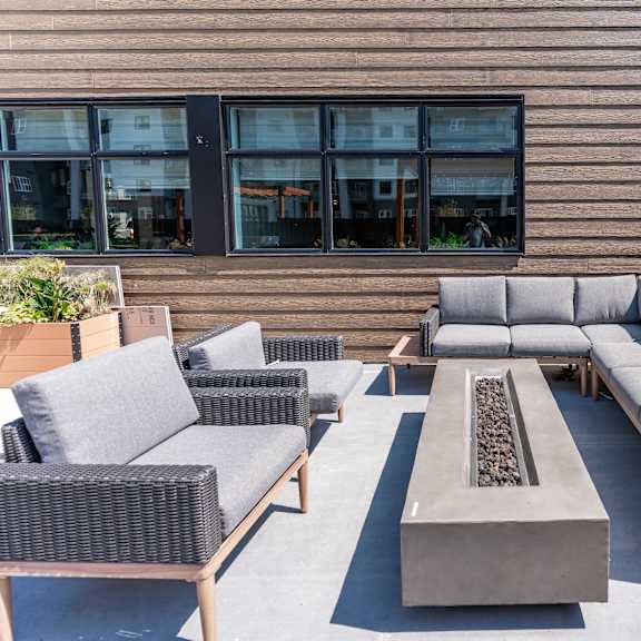 outdoor patio seating area with fire pit at mac and mullen apartments, edmonton, alberta