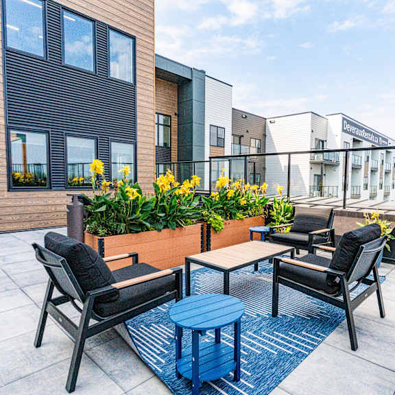 a patio with a table and chairs overlooking a building at vista apartments at edgemont, edmonton, ab