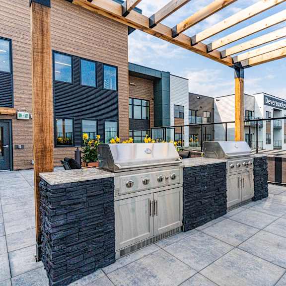 a patio with a grill and a table at vista apartments at edgemont, edmonton, ab