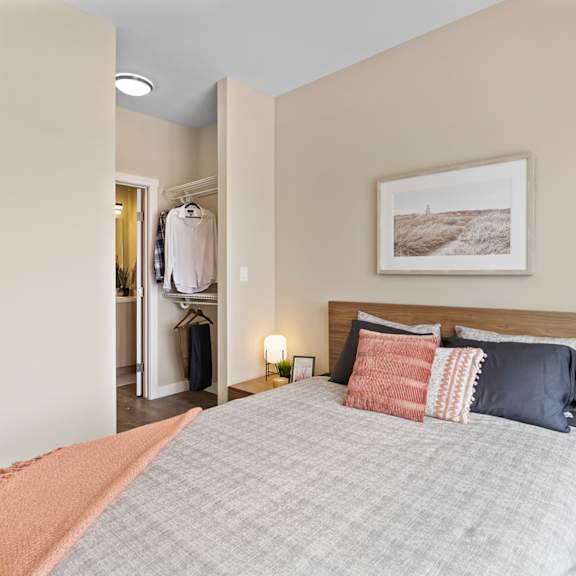 a bedroom with a large bed and a painting on the wall.