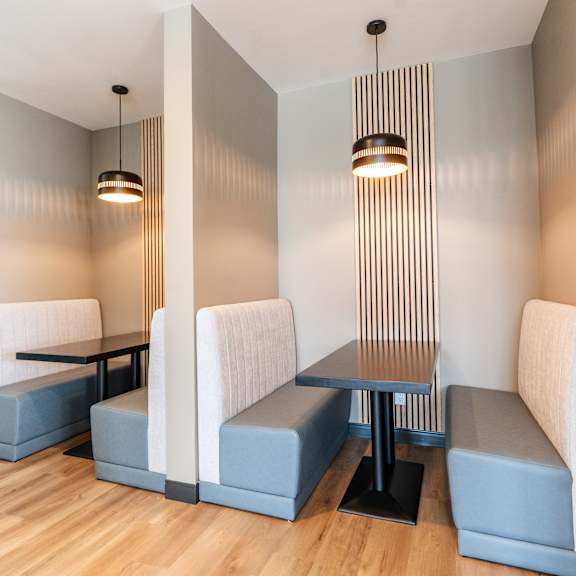 a modern dining area with a long table and chairs.
