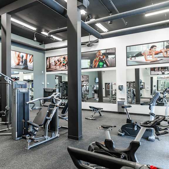 fully equipped fitness center with cardio and strength equipment at mac and mullen apartments, edmonton