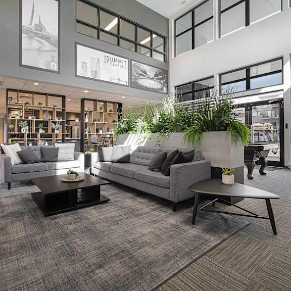 a living room with a grey couch and a coffee table.