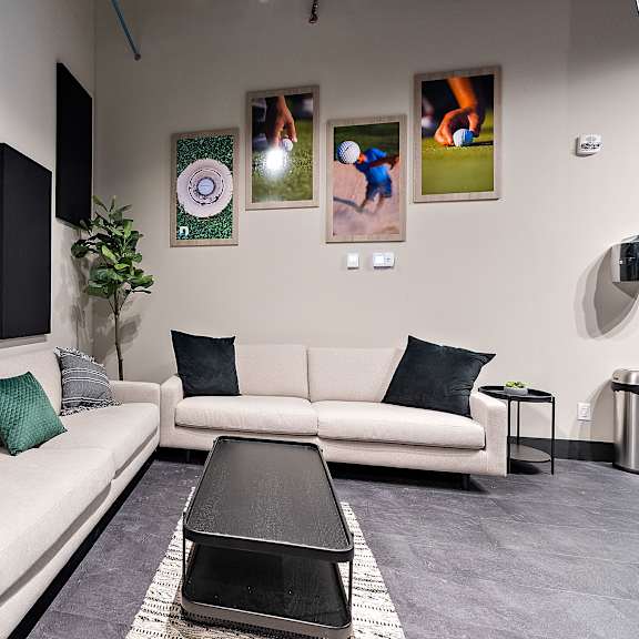 a living room with a white couch, a black coffee table, and a grey rug.at raymond block, alberta
