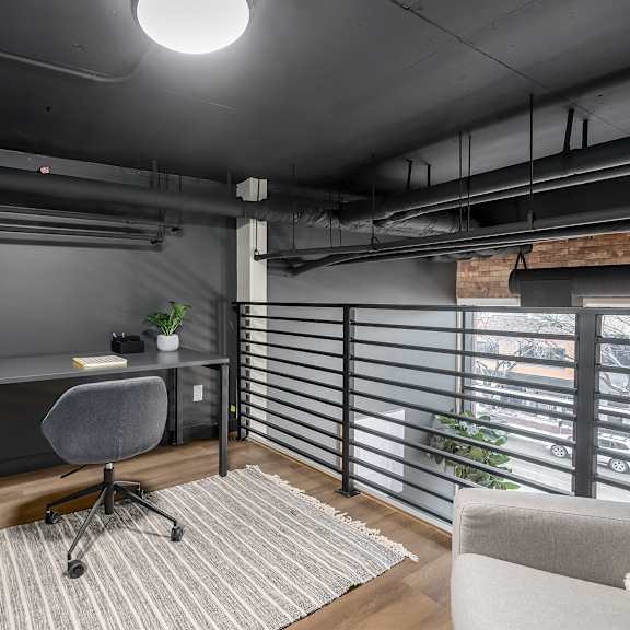 a modern home office with a desk, chair, and a window with blinds.at raymond block, alberta, t6e 3r7