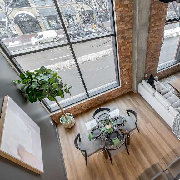 a living room with a glass table and a white couch.at raymond block, edmonton, ab t6e 3r7