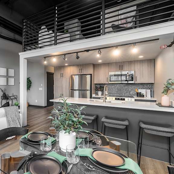 a modern dining area with a table set for a meal.at raymond block, edmonton, t6e 3r7