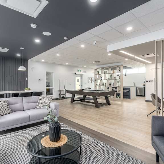 a modern living room with a grey sofa and a black coffee table.