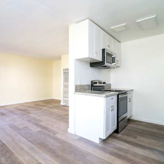 a kitchen with a microwave above the counter.