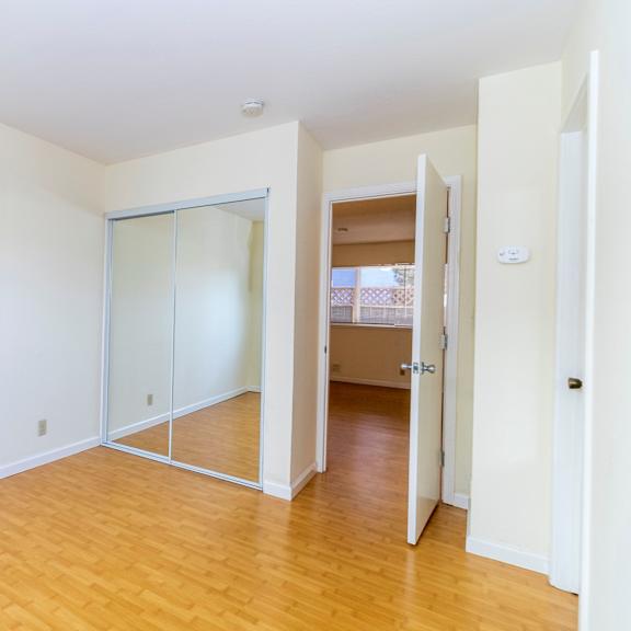 a room with a white wall and a wooden floor.