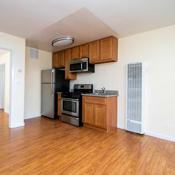 a kitchen with wooden cabinets and stainless steel appliances.