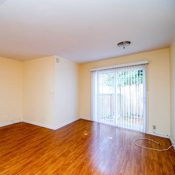 empty room with wooden floor and white walls.