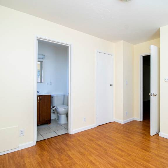 a room with a wooden floor and white walls.