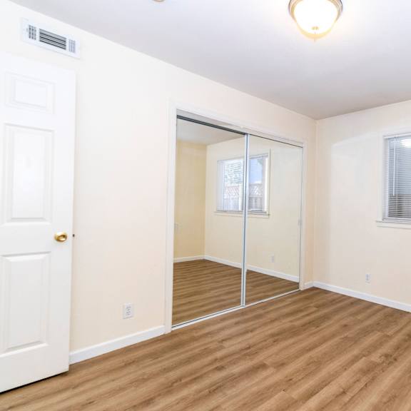 a room with a sliding glass door and a window.