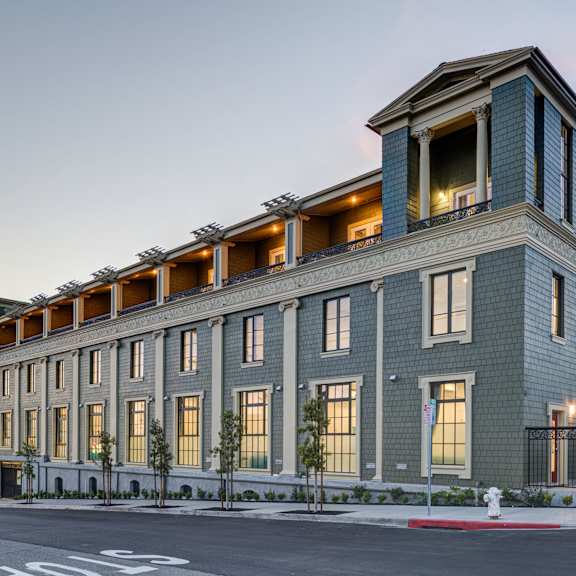 a large building with a balcony on the top floor is shown.