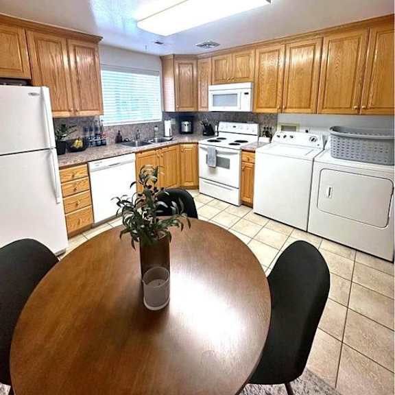 a kitchen with a table and chairs in the middle.