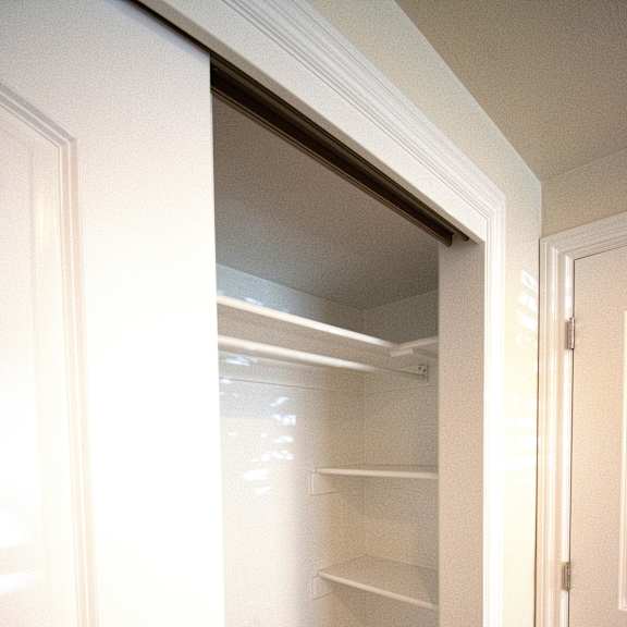 a white door is open to a hallway with a carpeted floor.