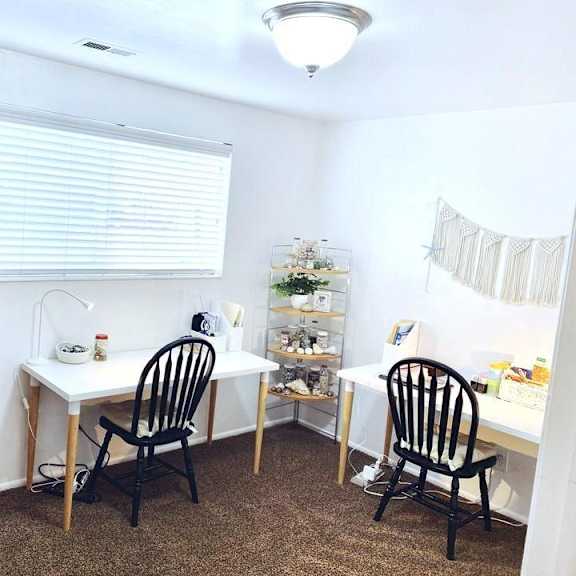 a room with a desk, chair, and a cabinet.