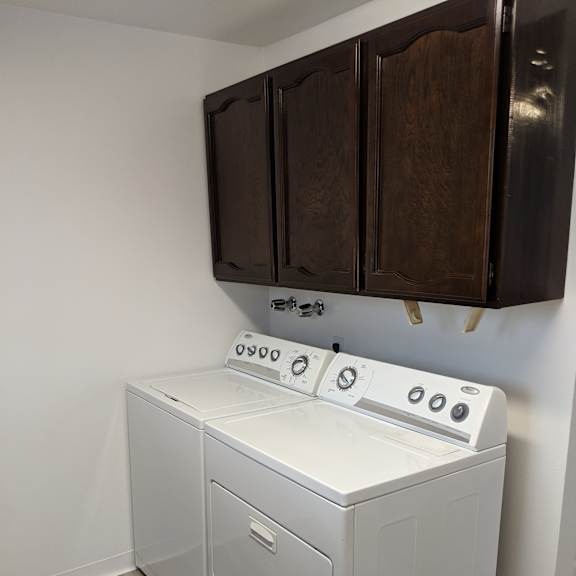 a white dishwasher and oven in a kitchen.