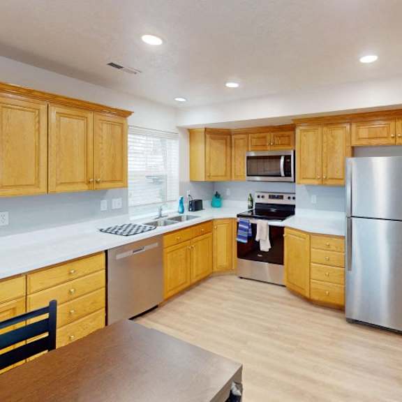a kitchen with wooden cabinets and stainless steel appliances.