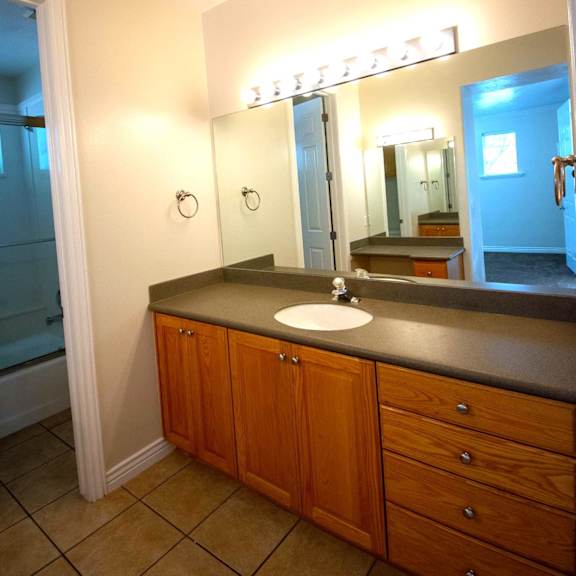 a bathroom with a sink and a mirror.